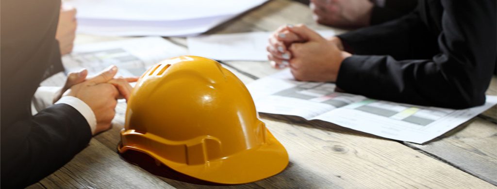 Business people with construction blueprint