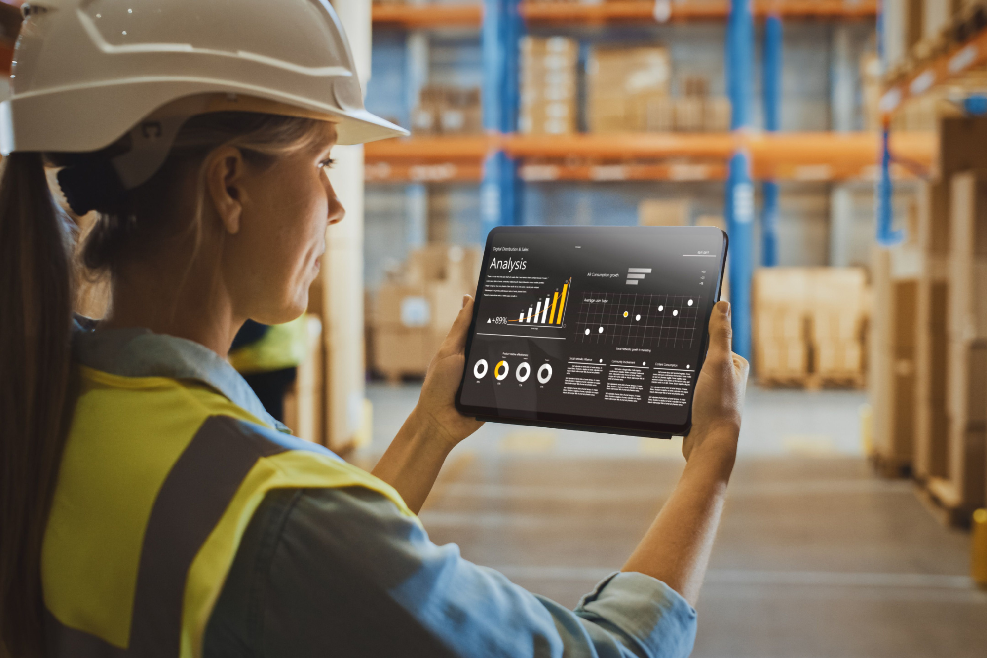 woman in hard hat looking at a safety analysis on a tablet