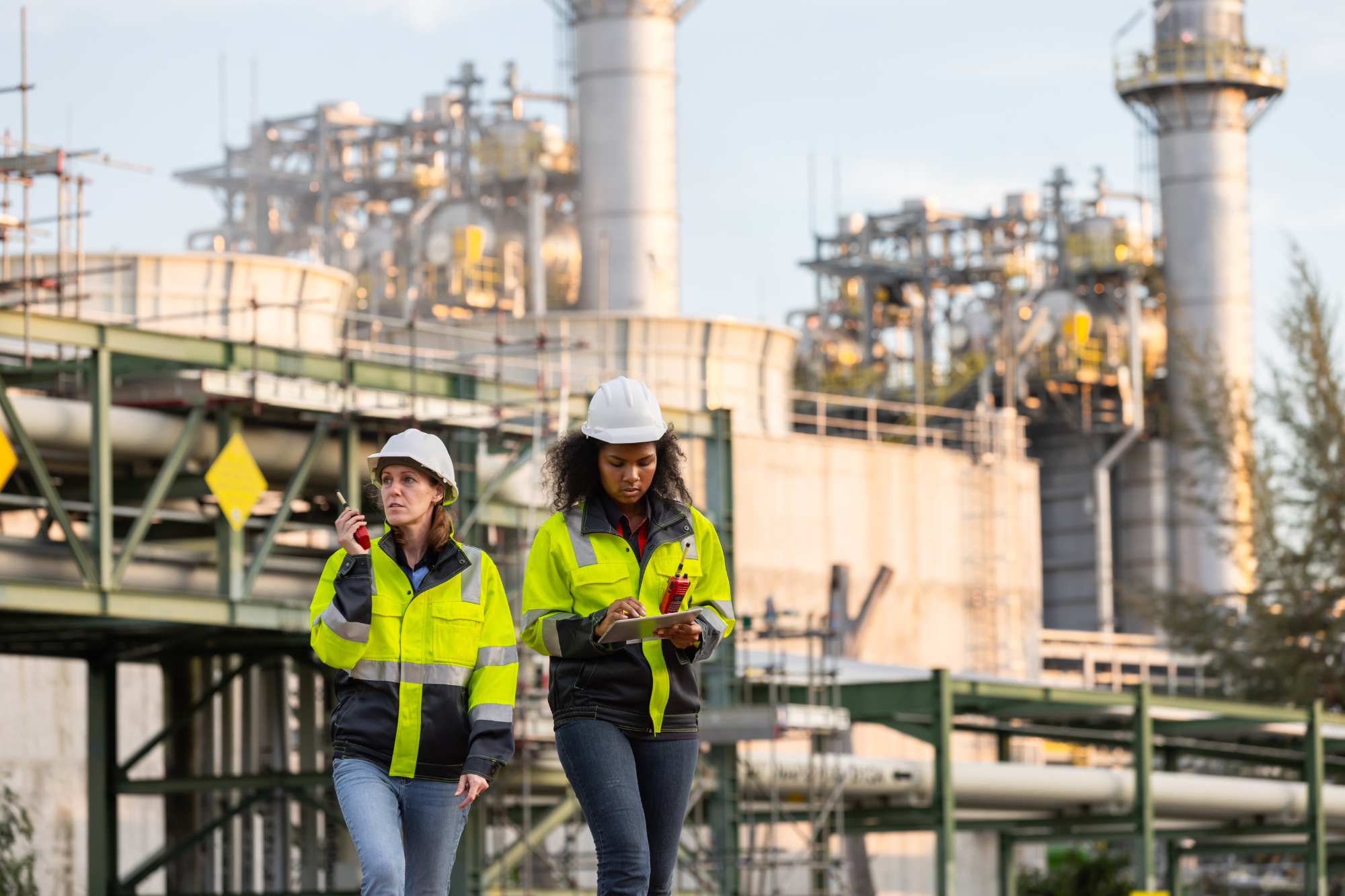 two female employees working outdoors in safety uniforms