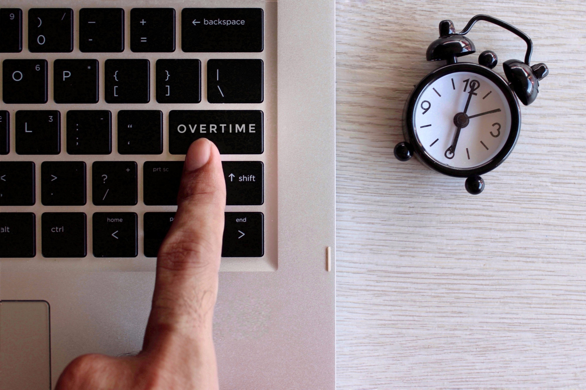 a laptop keyboard and clock