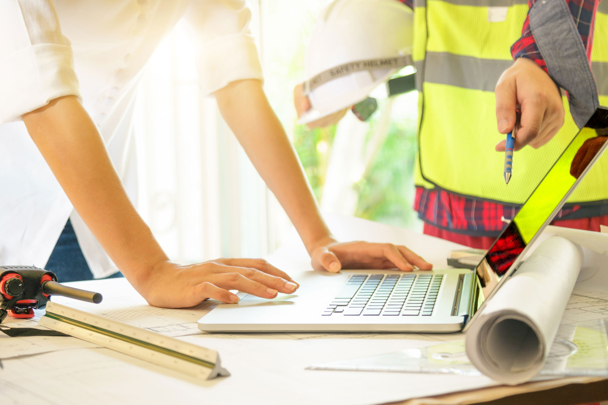 two safety workers looking at a laptop screen