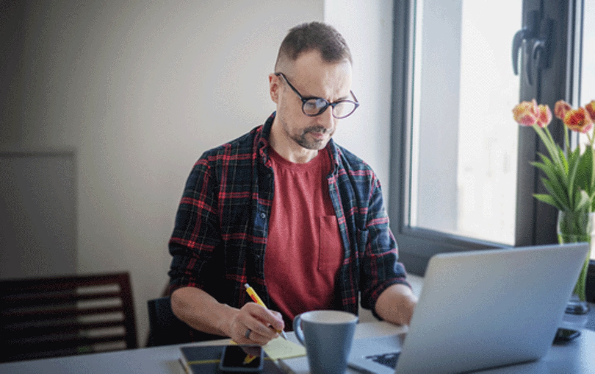 remote worker sitting at his laptop working