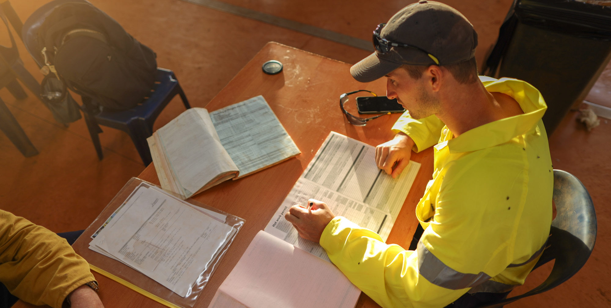 safety worker filling out a form on a desk