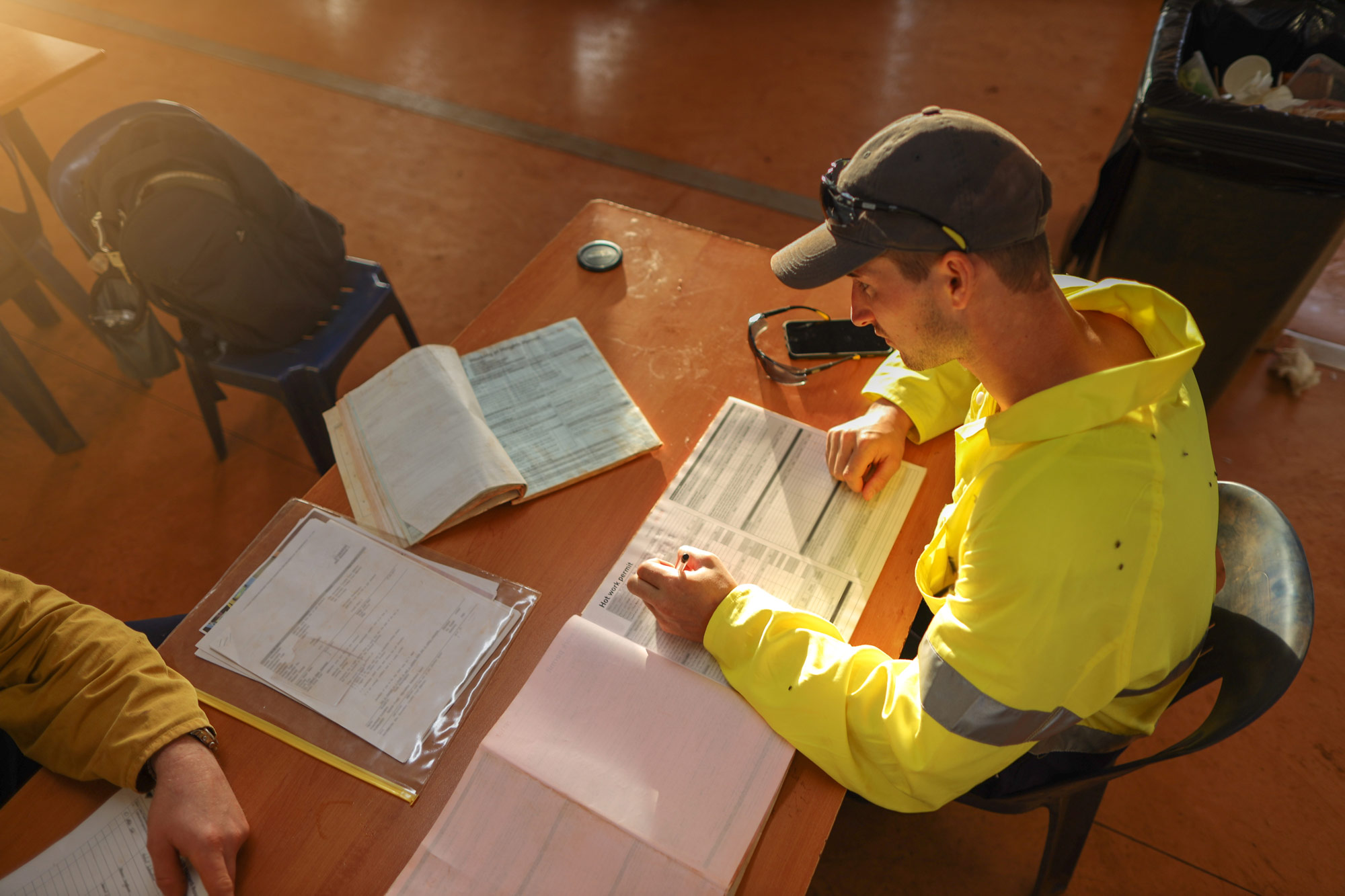 safety worker filling out a form on a desk