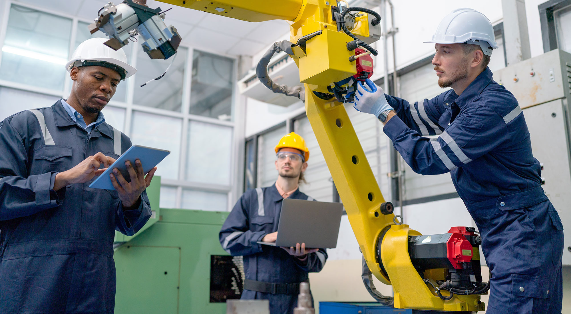 technician-working-with-team-to-check-robotic-arm