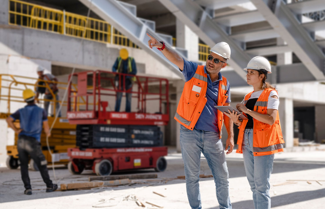 two-engineers-using-a-tablet-on-site