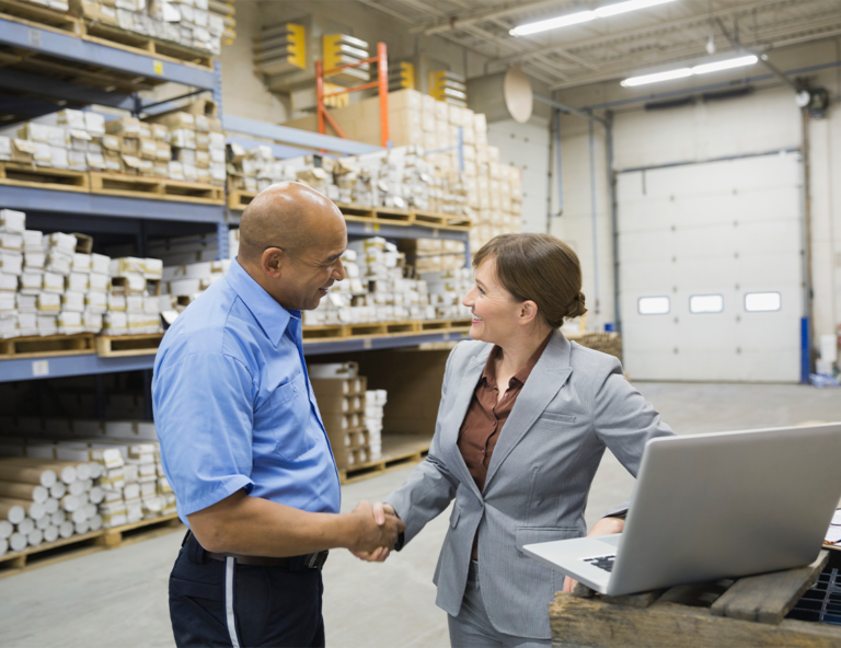 man-and-woman-shaking-hands-in-warehouse