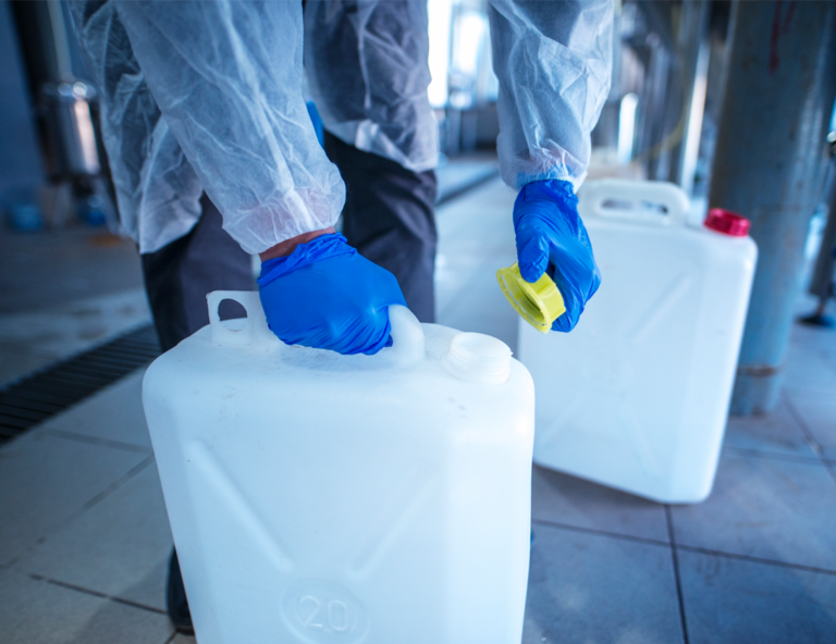 person-holding-jugs-with-ppe-on