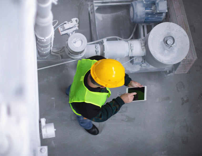 man-with-hard-hat-on-ipad