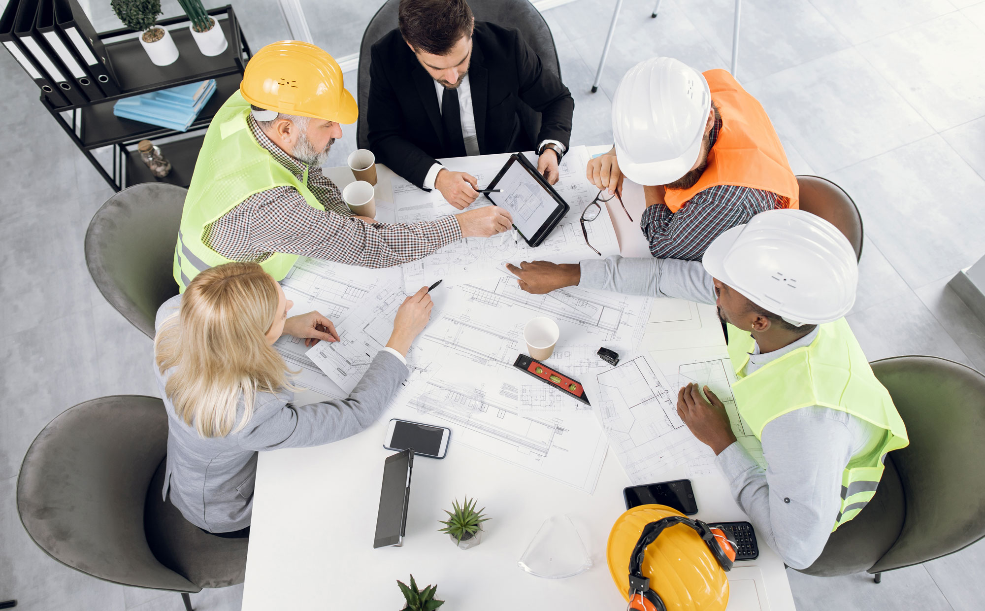 diverse-ehs-workers-sitting-around-a-table-making-plans