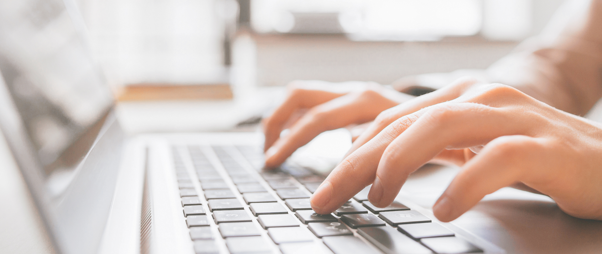 Employee typing on laptop