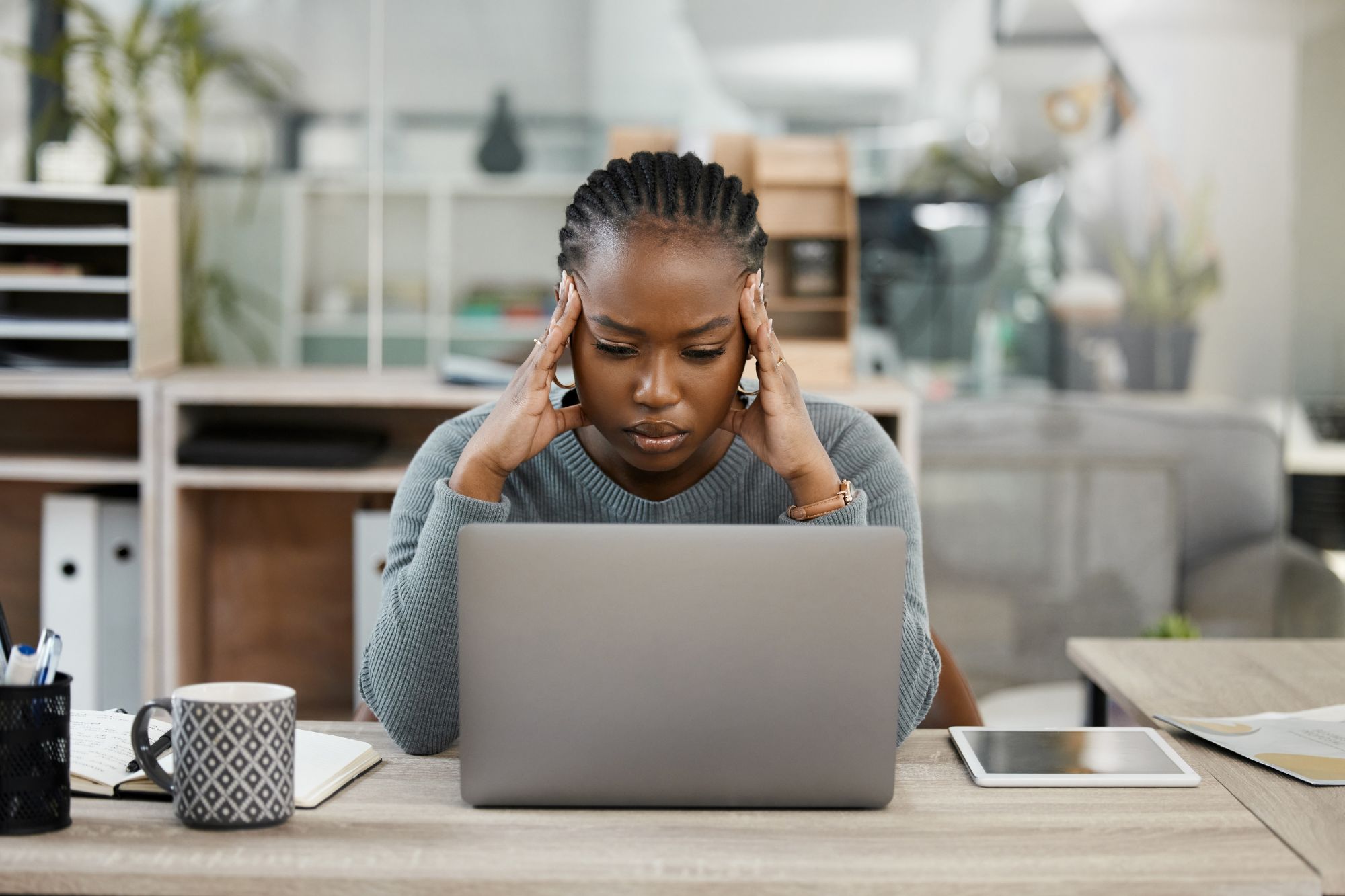 woman looking stressed at her computer