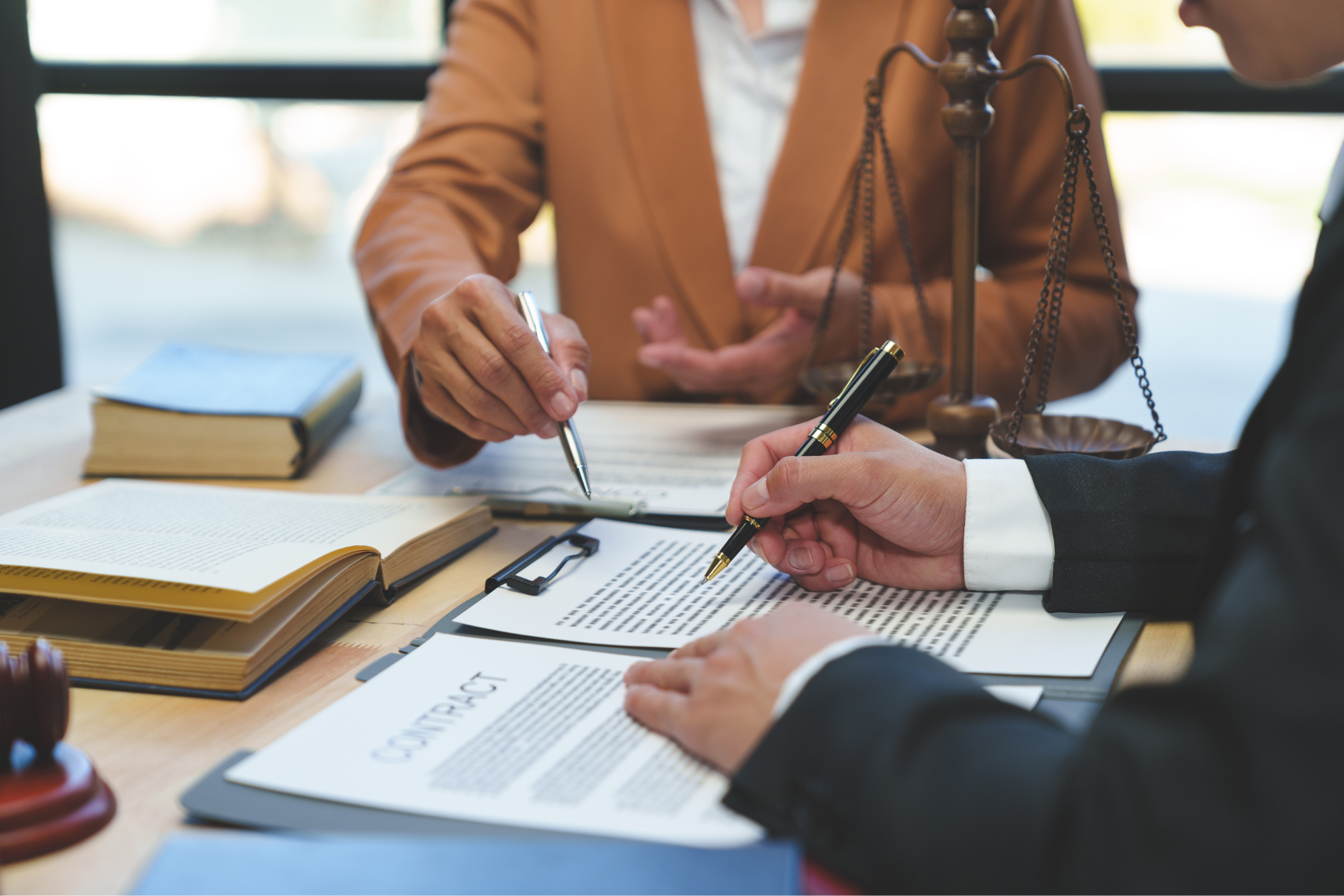 two people reviewing and signing a document