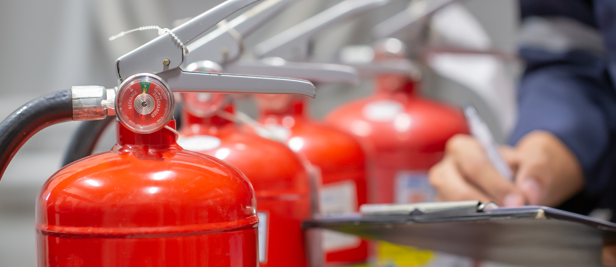 Employee checking fire extinguishers