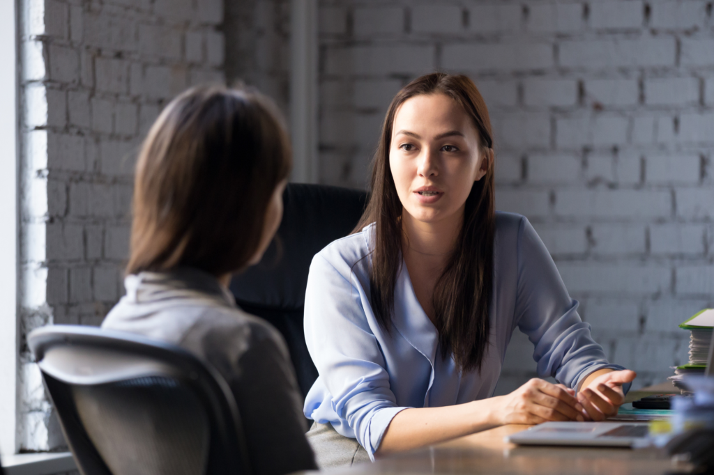 Two female professionals having a conversation about termination