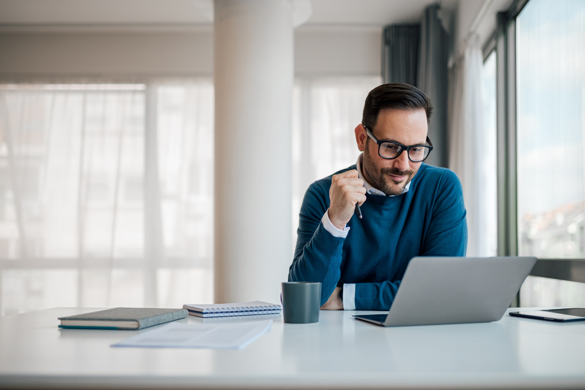 man using a computer at a desk