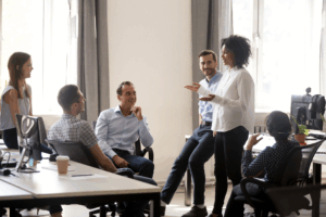 Black female manager leading a team training session on leadership skills in a diverse office setting