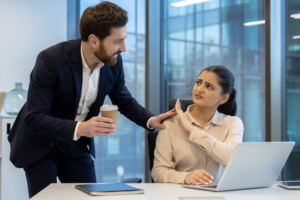 A-woman-at-work-rebuffs-unwanted-attention-from-a-male-colleague-conveying-discomfort-and-rejection-with-body-language