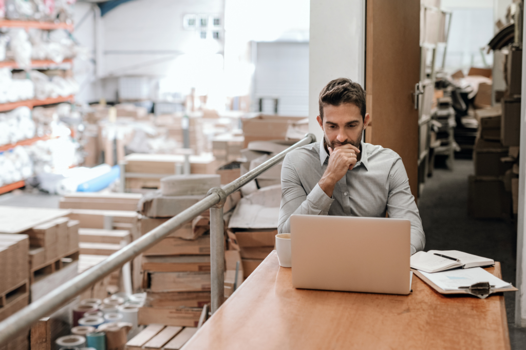 HR Manager working online while sitting in a factory office
