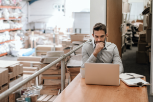 HR Manager working online while sitting in a factory office