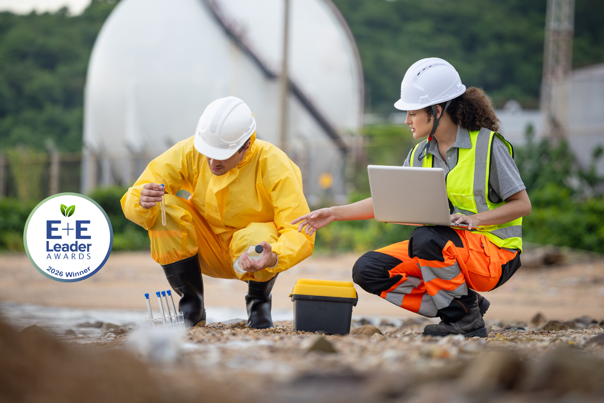 Environmental researchers analyzing water samples and recording data