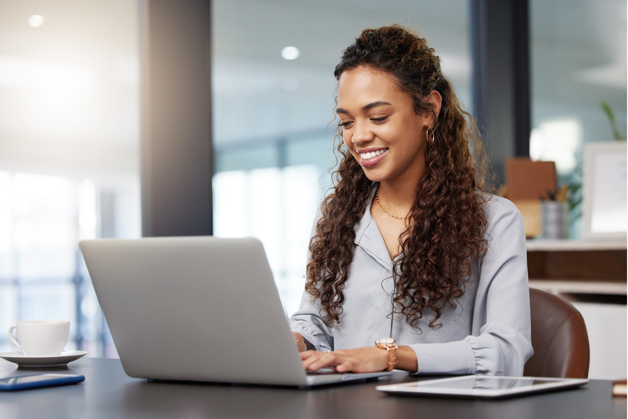 Happy working typing on a laptop