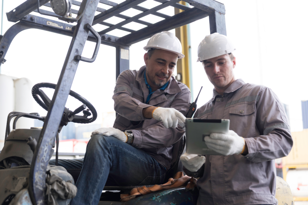Male worker wearing safety uniform, helmet and gloves at work.