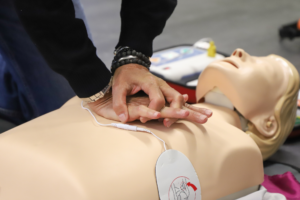Employee performing basic first aid during workplace first aid and emergency response training.